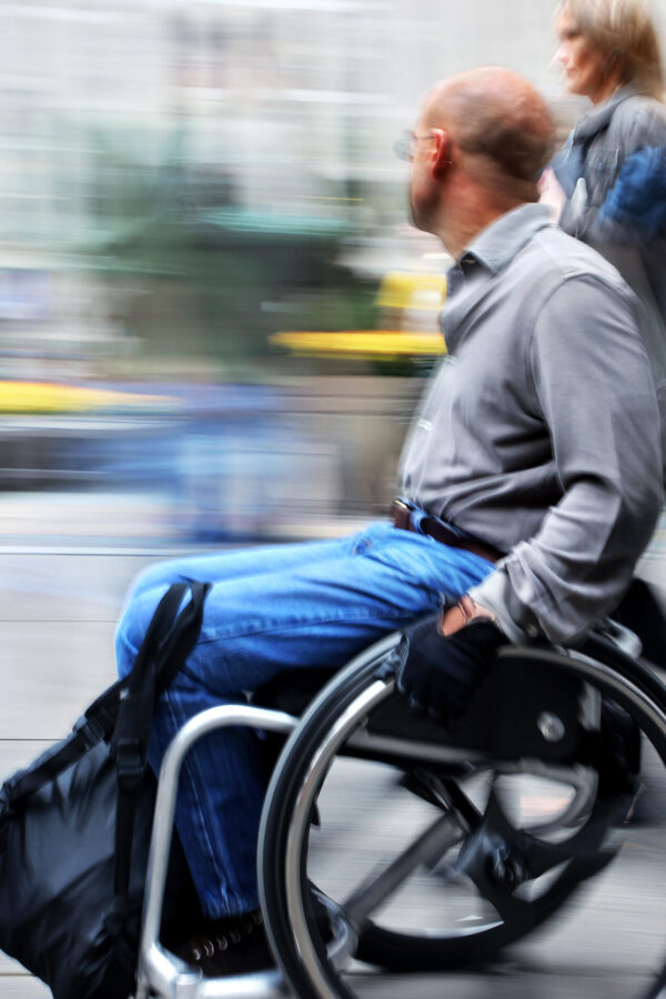 blurred movement disabled on a city street