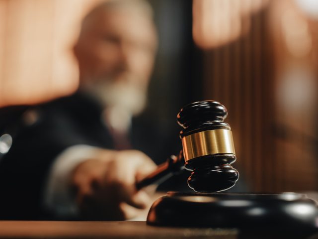 Court of Law and Justice Trial Session: Imparcial Honorable Judge Pronouncing Sentence, striking Gavel. Focus on Mallet, Hammer. Cinematic Shot of Dramatic Not Guilty Verdict. Close-up Shot.