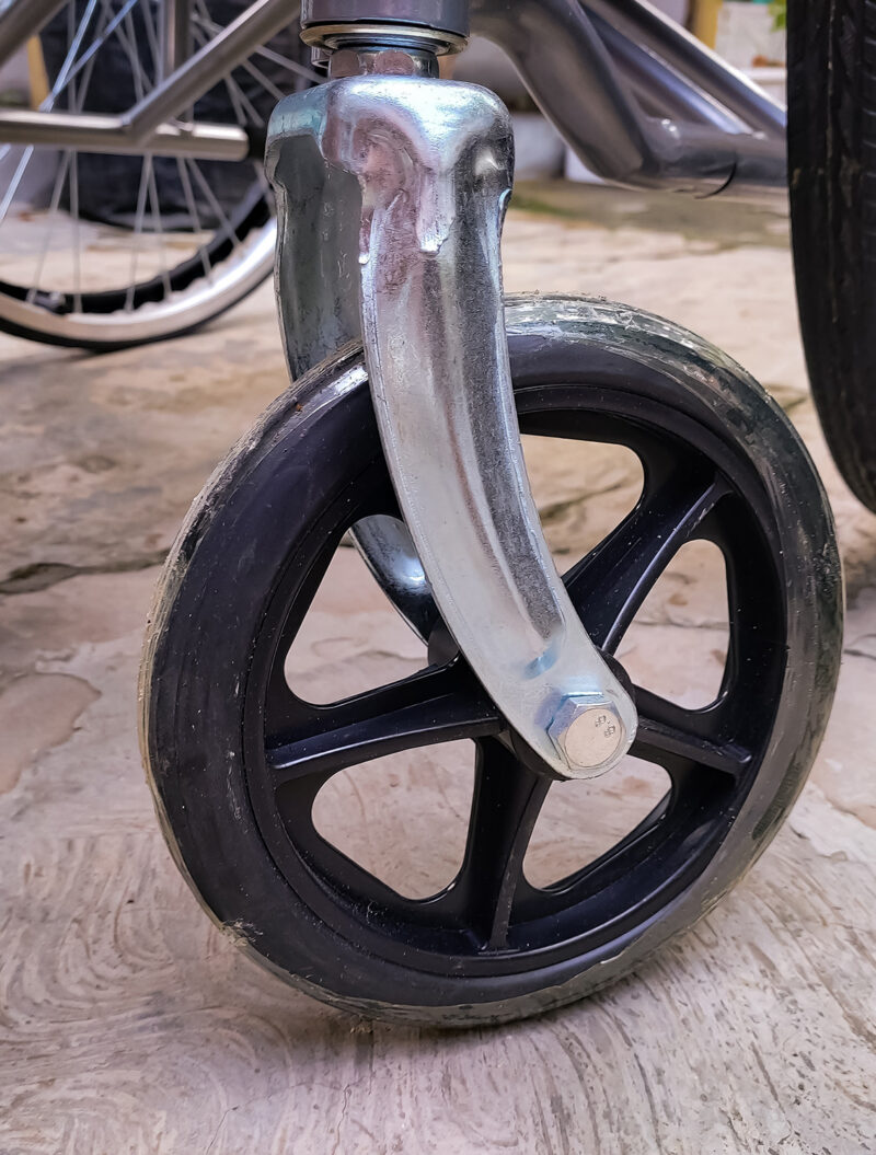 The front wheels of the wheelchair are smaller and move freely